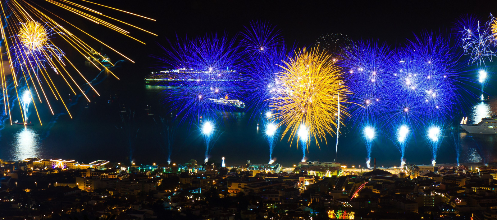 Fireworks display over a cityscape at night